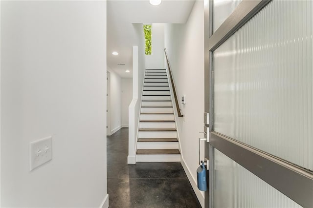 staircase with concrete flooring