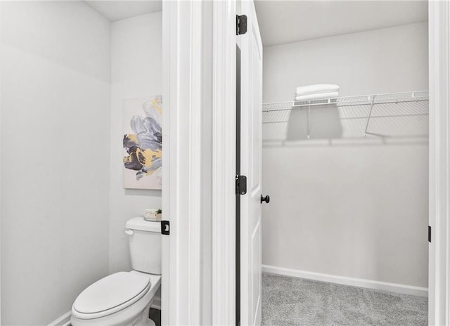 76 Ridge Way Unit 38, Hartwell, GA 30643 - bathroom featuring a walk in closet, toilet, and baseboards