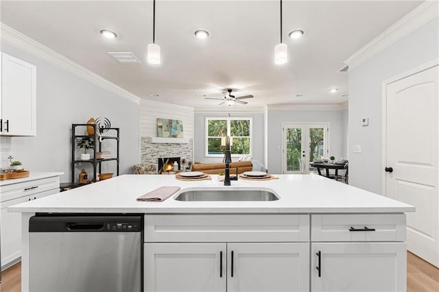 76 Ridge Way Unit 38, Hartwell, GA 30643 - kitchen with stainless steel dishwasher, open floor plan, ceiling fan, a sink, and a lit fireplace