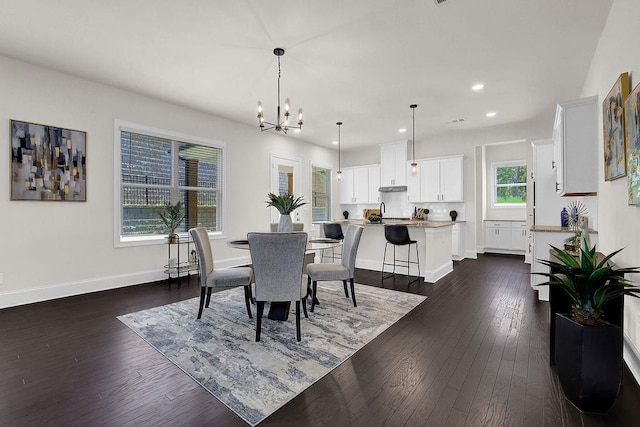 dining area with a healthy amount of sunlight, a chandelier, and dark wood-type flooring