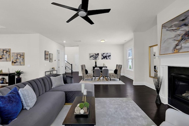 living room with ceiling fan and dark hardwood / wood-style floors