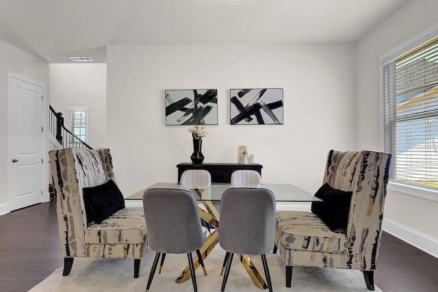 dining area with dark wood-type flooring and a healthy amount of sunlight