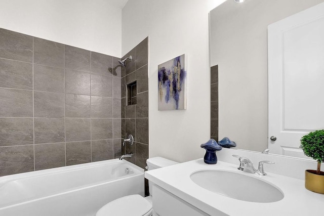 full bathroom featuring toilet, vanity, and tiled shower / bath