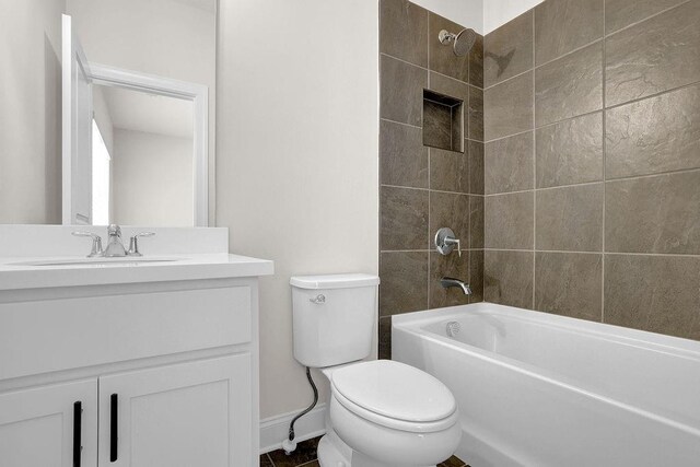 full bathroom with vanity, toilet, and tiled shower / bath combo