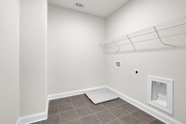 laundry room with dark tile patterned floors, electric dryer hookup, and hookup for a washing machine