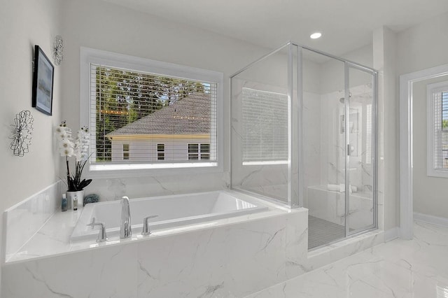 bathroom featuring separate shower and tub and a wealth of natural light