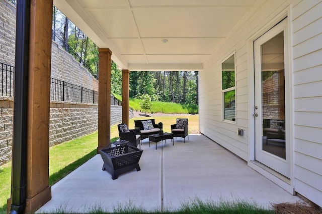 view of patio / terrace with an outdoor living space with a fire pit