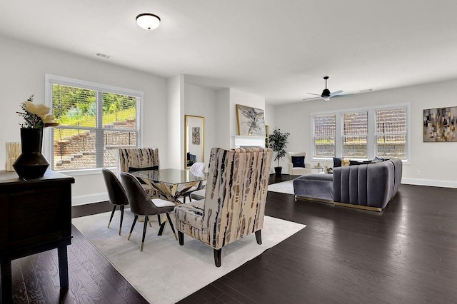 dining space featuring ceiling fan and dark hardwood / wood-style flooring