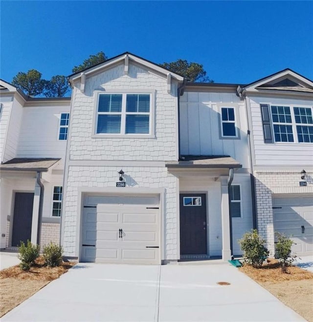 view of front facade featuring concrete driveway and a garage