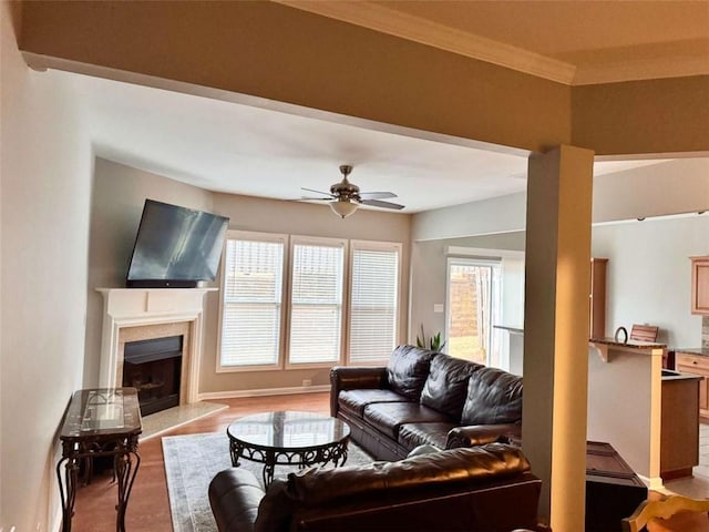 living room with ceiling fan and ornamental molding