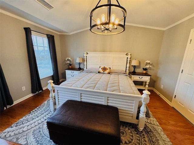 bedroom featuring wood-type flooring, crown molding, and a notable chandelier