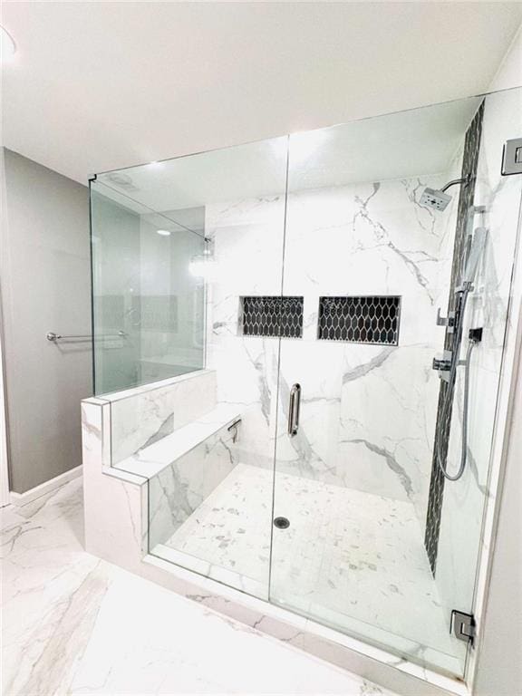 bathroom featuring a shower with shower door