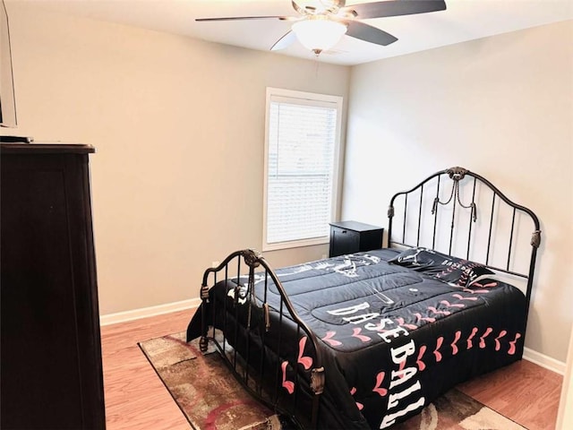 bedroom with ceiling fan and hardwood / wood-style flooring