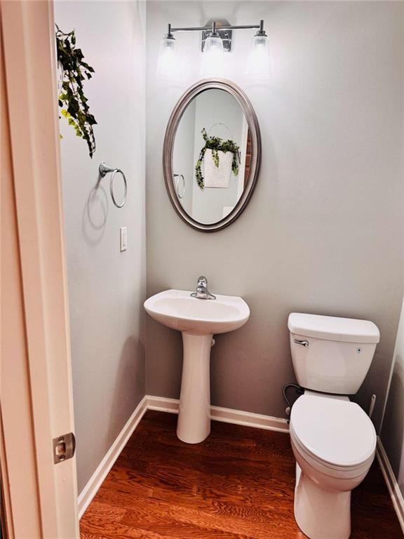 bathroom featuring sink, toilet, and hardwood / wood-style floors