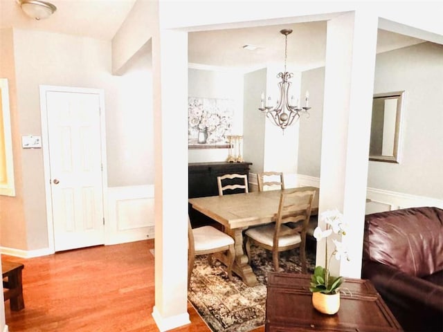 dining space featuring a notable chandelier and wood-type flooring