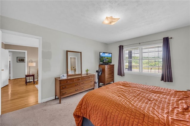 carpeted bedroom with baseboards