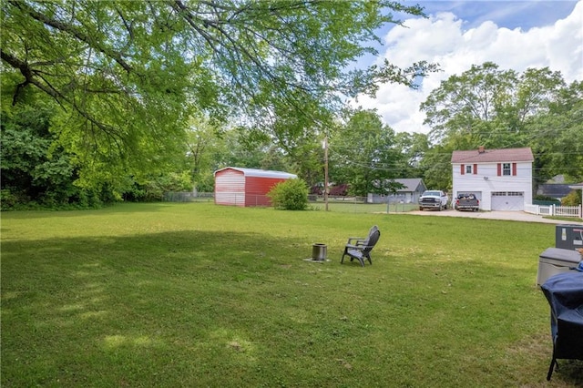 view of yard with a storage shed, fence, and an outdoor structure