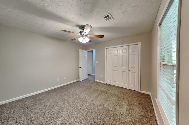 650 Lake Forest Ct, Roswell, GA 30076 - unfurnished bedroom featuring carpet flooring, a closet, a textured ceiling, and a ceiling fan