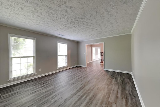 650 Lake Forest Ct, Roswell, GA 30076 - empty room featuring wood finished floors, ornamental molding, plenty of natural light, and a textured ceiling
