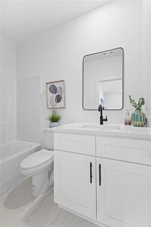 full bathroom featuring toilet, marble finish floor, and vanity