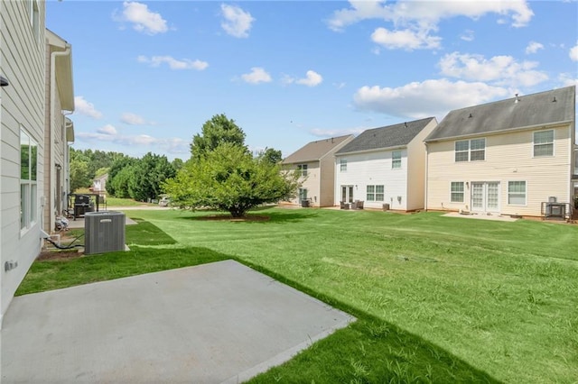 view of yard featuring cooling unit, a patio, and a residential view