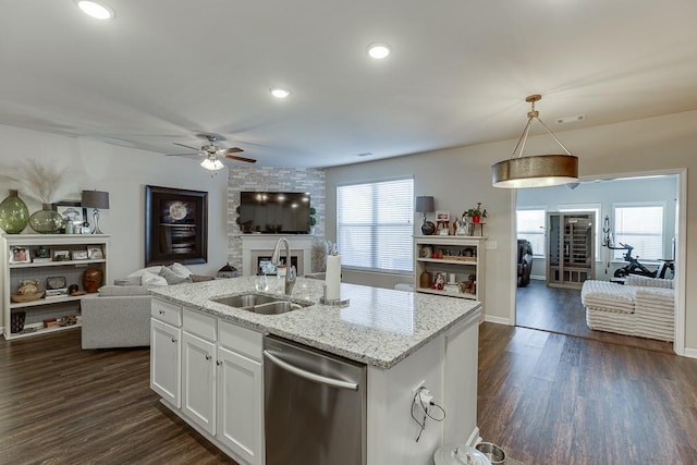 kitchen featuring a sink, dark wood-style floors, open floor plan, light stone countertops, and dishwasher