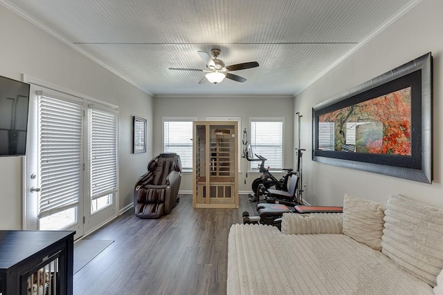 interior space with a ceiling fan, baseboards, ornamental molding, and wood finished floors