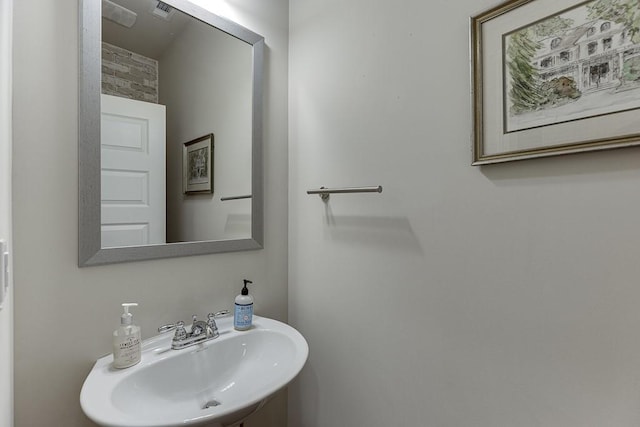 bathroom featuring visible vents and a sink