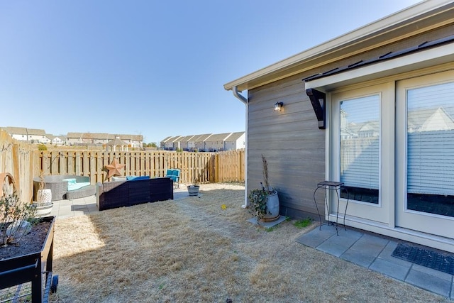 view of yard with outdoor lounge area, fence, and a patio