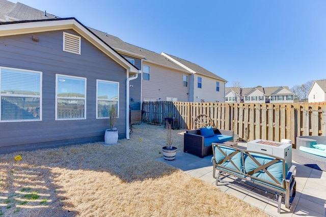 exterior space with an outdoor fire pit, fence, and a residential view