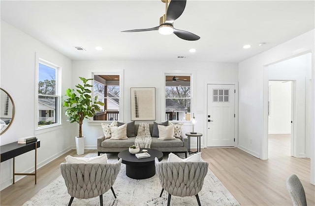 living area featuring recessed lighting, a ceiling fan, and light wood finished floors