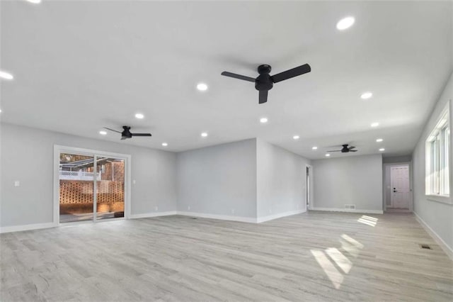 unfurnished living room with ceiling fan and light wood-type flooring