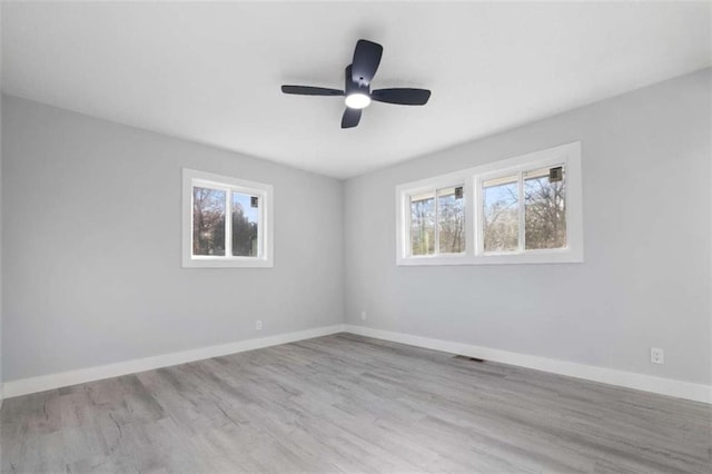 unfurnished room with ceiling fan and light hardwood / wood-style floors