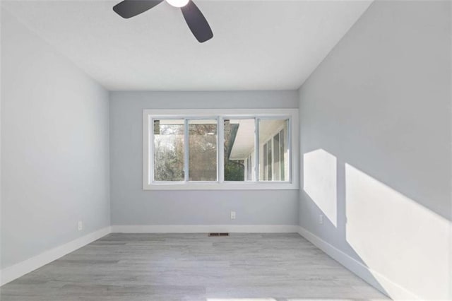 spare room featuring ceiling fan and light wood-type flooring