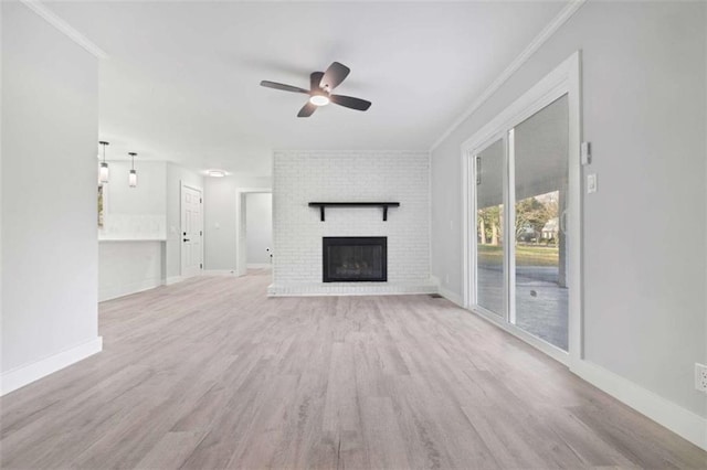 unfurnished living room with light hardwood / wood-style flooring, crown molding, a fireplace, and ceiling fan