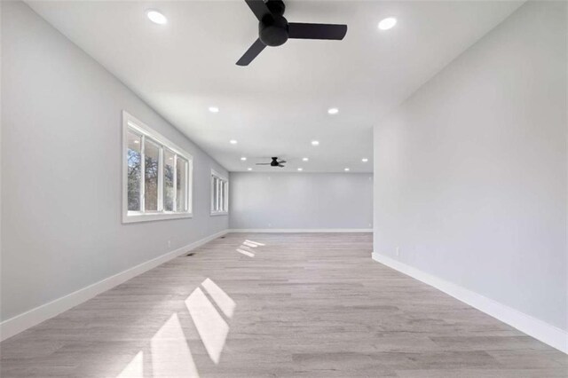 empty room featuring ceiling fan and light wood-type flooring