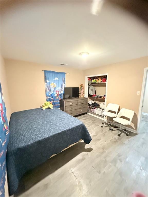 bedroom featuring a closet and light hardwood / wood-style floors