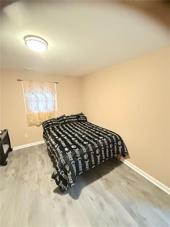 bedroom with hardwood / wood-style floors