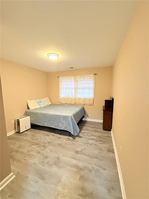 bedroom with hardwood / wood-style flooring