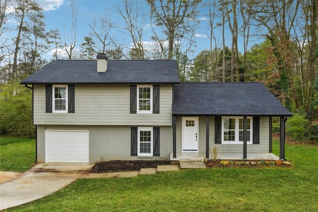 tri-level home featuring a garage and a front lawn