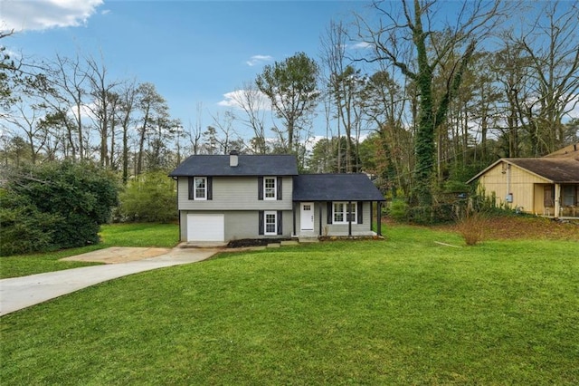 view of front of property with a garage and a front yard