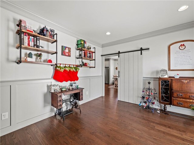 miscellaneous room featuring a barn door, dark hardwood / wood-style floors, and crown molding