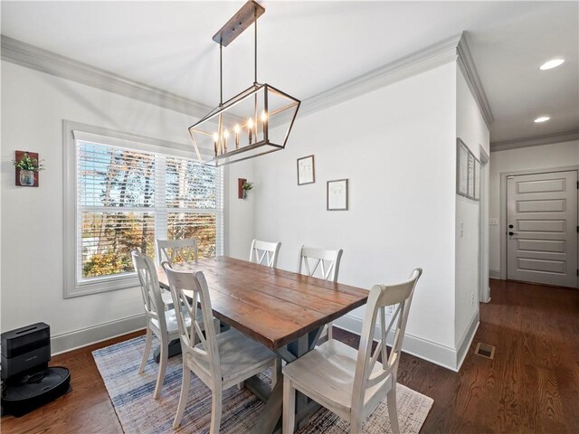 dining area with crown molding, a chandelier, and dark hardwood / wood-style floors