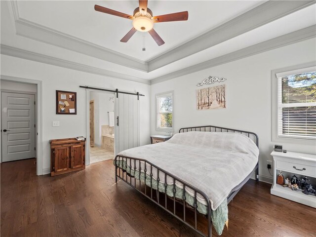 bedroom featuring ensuite bath, ceiling fan, a barn door, dark hardwood / wood-style flooring, and crown molding