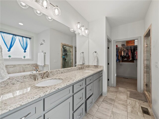 bathroom featuring vanity and a shower with shower door