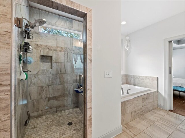 bathroom with tile patterned floors and separate shower and tub