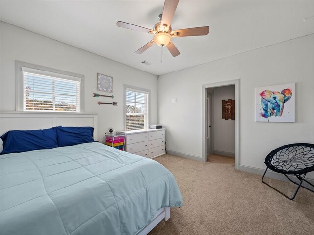 bedroom with ceiling fan and light carpet