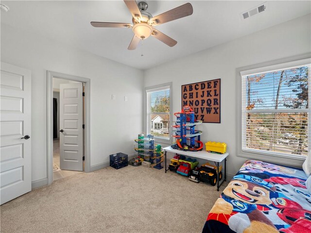 carpeted bedroom with ceiling fan