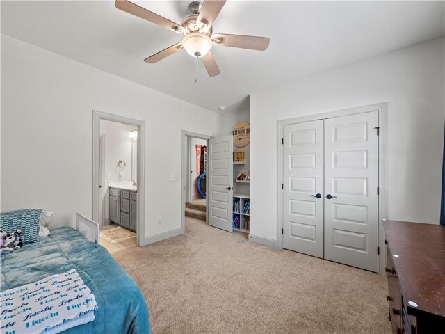 carpeted bedroom with ceiling fan, ensuite bathroom, and a closet