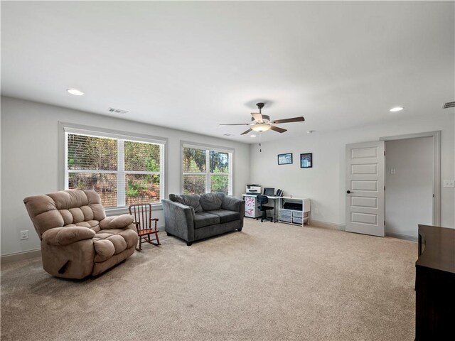 living room with ceiling fan and light carpet